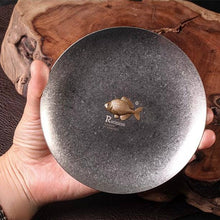 Load image into Gallery viewer, Rhodeus Plate held in one hand to show its size, about 130 mm across